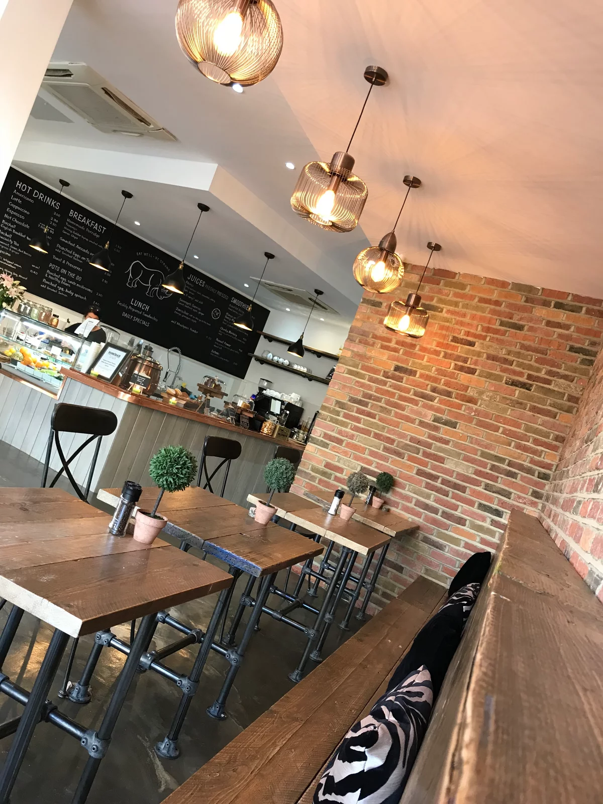 Cafe with brick wall and wooden tables