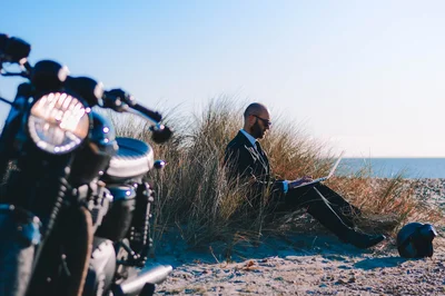Man on beach with motorbike
