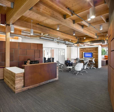 open plan reception area with wood panel desk