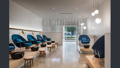 Blue arm chairs lined up in salon